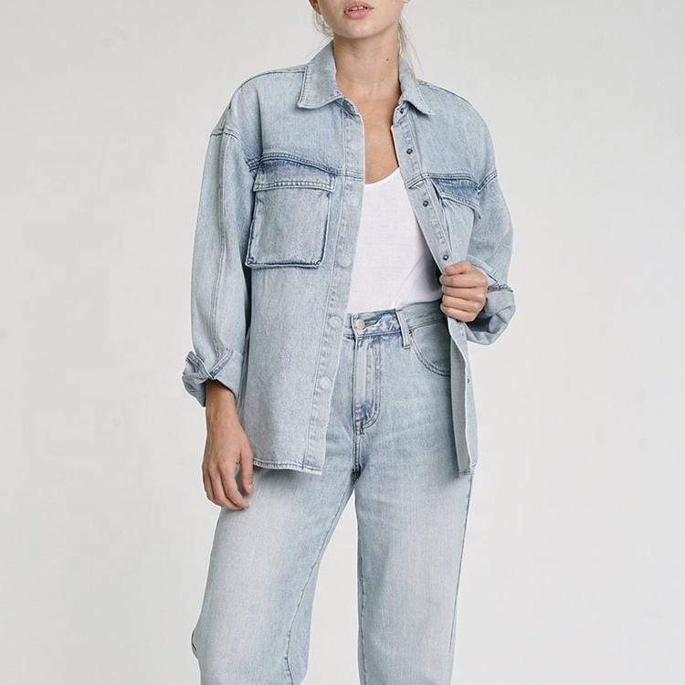 Front full view of wholesale fashion women's denim jacket with functional chest pockets in classic blue