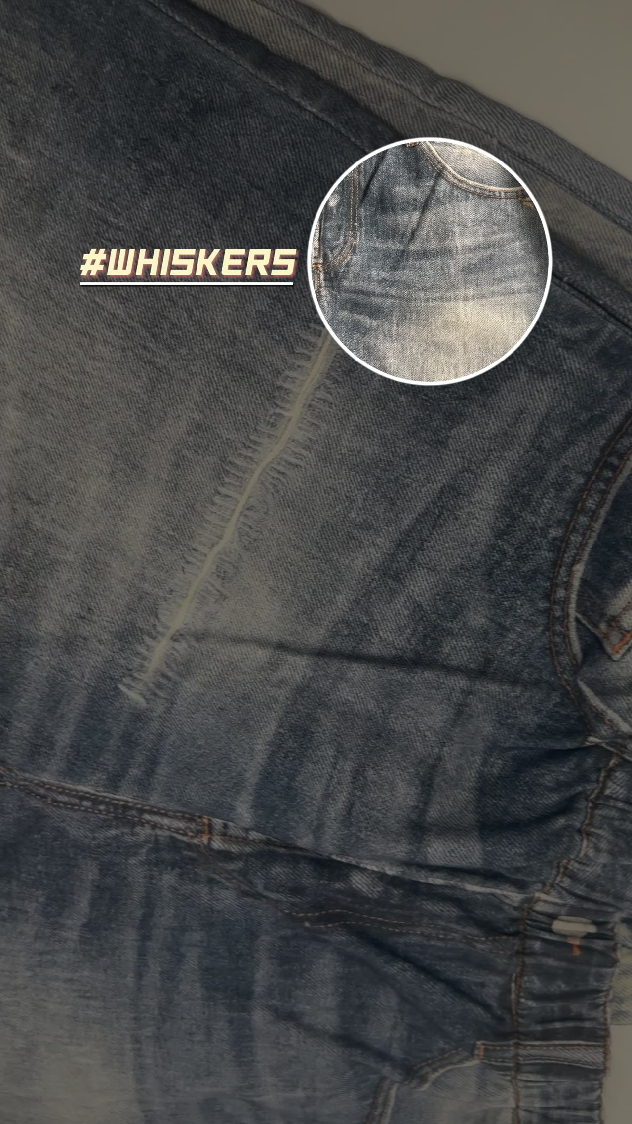 Close-up of printed whisker and fading effects on denim-look fabric